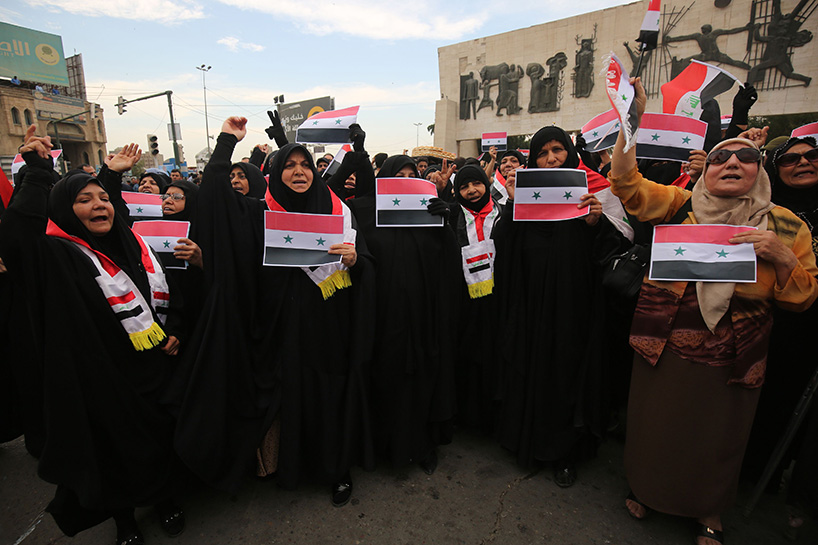 Iraqi protestors burn a US flag during a protest in Baghdad on Sunday opposing the joint Western airstrikes against Syria's regime. (Photo: AFP)