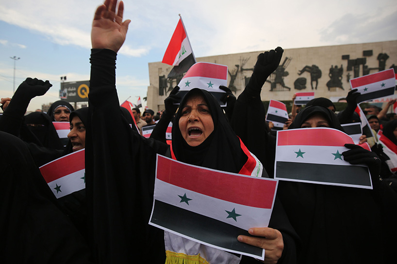 Iraqi protestors burn a US flag during a protest in Baghdad on Sunday opposing the joint Western airstrikes against Syria's regime. (Photo: AFP)