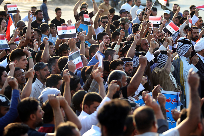 Iraqi protestors burn a US flag during a protest in Baghdad on Sunday opposing the joint Western airstrikes against Syria's regime. (Photo: AFP)