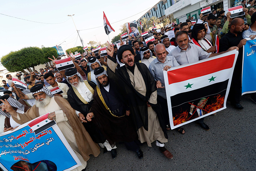 Iraqi protestors burn a US flag during a protest in Baghdad on Sunday opposing the joint Western airstrikes against Syria's regime. (Photo: AFP)