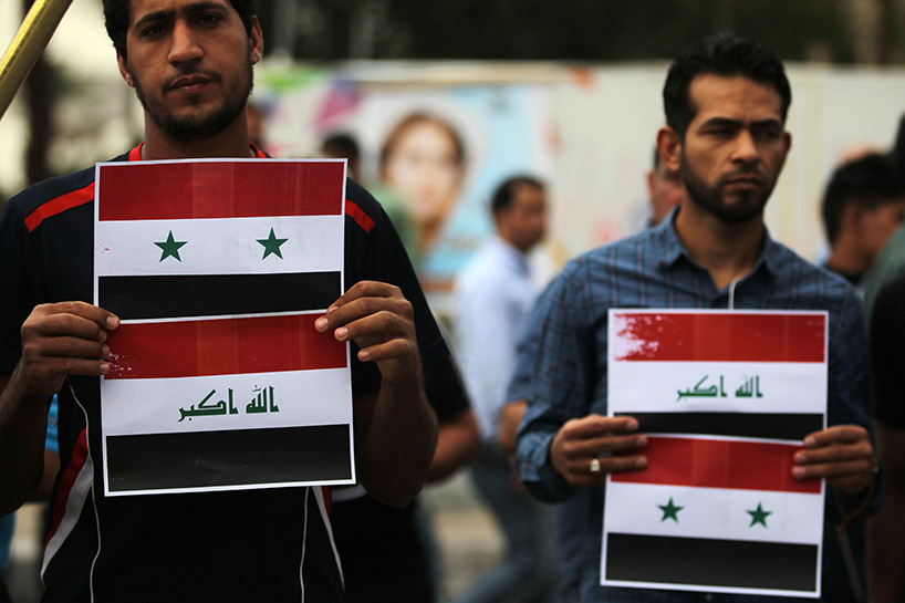 Iraqi protestors burn a US flag during a protest in Baghdad on Sunday opposing the joint Western airstrikes against Syria's regime. (Photo: AFP)
