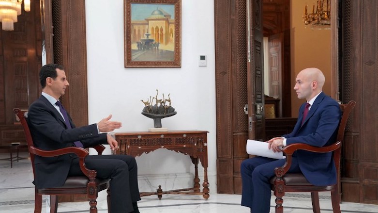 A handout picture released by the official Facebook page of the Syrian Presidency on May 31, 2018, shows Syrian President Bashar al-Assad (L) giving an interview to a journalist from Russia Today in the capital Damascus. (Photo: AFP/Syrian Presidency Facebook page)