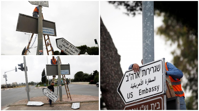 Workers hangs a road sign directing to the US Embassy, in the area of the US consulate in Jerusalem, May 7, 2018. (Photo: Reuters/Ronen Zvulun)