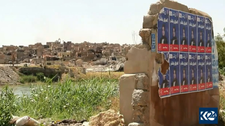 دیوارە وێرانبووەکانی مووسڵ بە پۆستەری کاندیدەکان دادەپۆشرێن