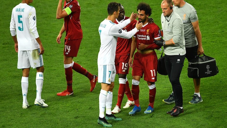 Real Madrid forward Cristiano Ronaldo (7) consoles Liverpool's Mohamed Salah (11) after he was forced off through injury in the first-half of the UEFA Champions League final football match between Liverpool and Real Madrid at the NSC Olimpiyskiy Stadium in Kiev, Ukraine on May 26, 2018.  (Photo: AFP/Sergei Supinsky)
