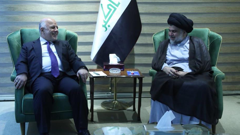 Iraqi Prime Minister and head of the al-Nasr (Victory) Haider al-Abadi (left) met with the head of the Sairoon alliance, Muqtada al-Sadr, in Baghdad, May 19, 2018. (Photo: Sadr's media office)