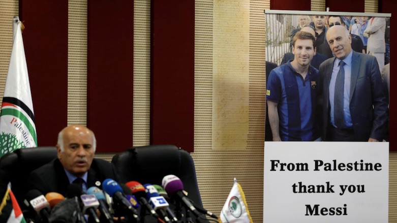 A poster of Palestinian FA chief Jibril Rajoub with Argentina's soccer player Lionel Messi, in Ramallah in the occupied West Bank, June 6, 2018. (Photo: Reuters/Mohamad Torokman)