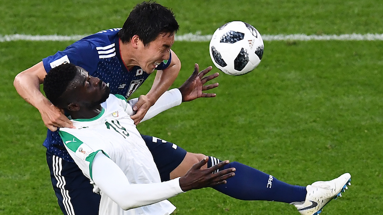 Japan's defender Gen Shoji (right) vies with Senegal's forward Mbaye Niang during the 2018 World Cup Group H football match between Japan and Senegal at the Ekaterinburg Arena in Ekaterinburg, Russia, on June 24, 2018. (Photo: AFP/Anne-Christine Poujoulat)
