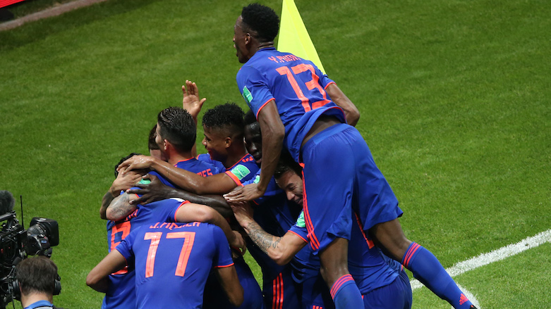 Colombia's players celebrate after scoring their second goal during the 2018 World Cup Group H football match between Poland and Colombia at the Kazan Arena in Kazan, Russia, on June 24, 2018. (Photo: AFP/Roman Kruchinin)
