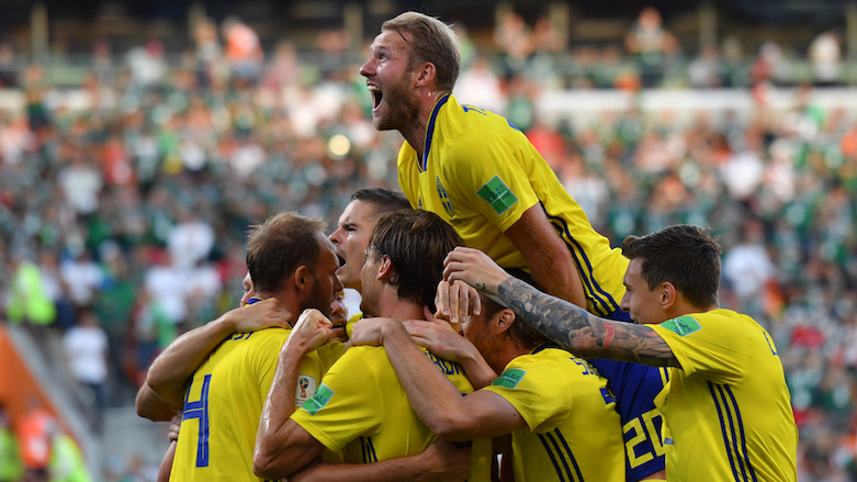 Sweden's defender Andreas Granqvist (left) celebrates with teammates after scoring a penalty during the 2018 World Cup Group F football match between Mexico and Sweden at the Ekaterinburg Arena in Ekaterinburg, Russia, on June 27, 2018. (Photo: AFP/Hector Retamal)