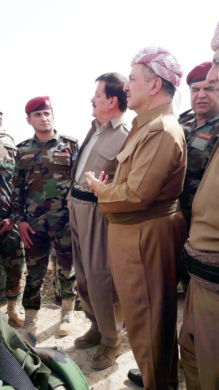 KDP President Masoud Barzani (right) and Peshmerga Commander Kemal Kirkuki speak during the Kurdish leader's visit to troops near the town of Perde (Altun Kupri), north of Kirkuk, on June 16, 2018.