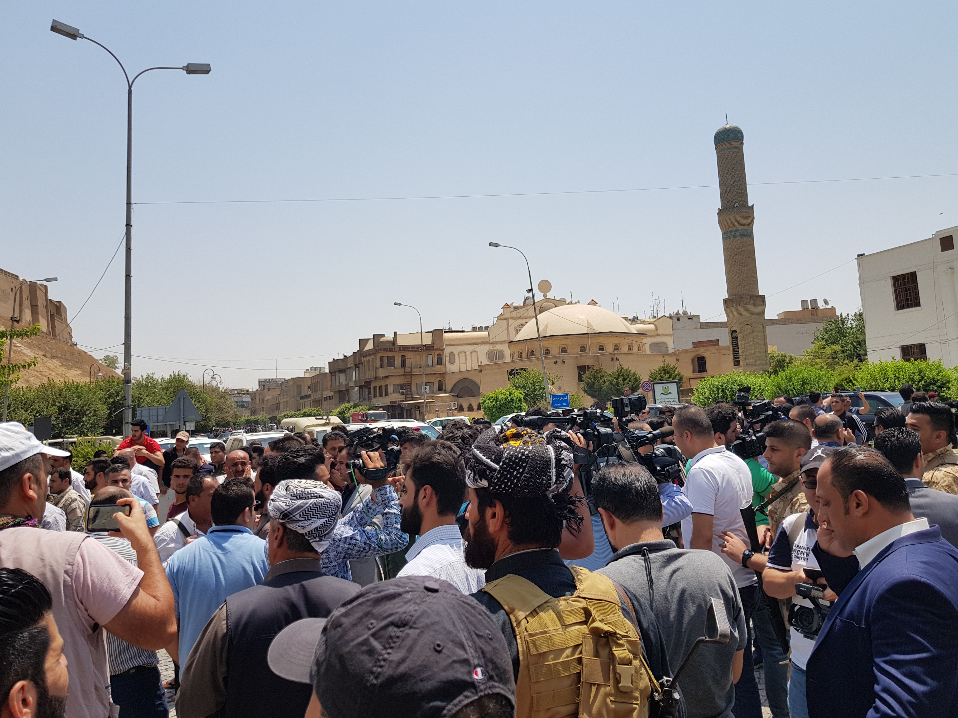 People gather outside of the Erbil Governorate building where an attack took place early in the morning, July 23, 2018. (Photo: Kurdistan 24/Wladimir van Wilgenburg)