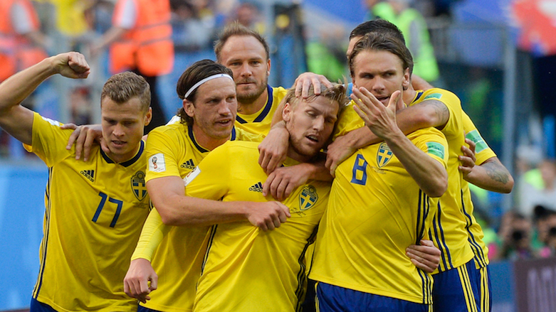 Teammates congratulate Sweden's midfielder Emil Forsberg (center) after he scored during the 2018 World Cup Round of 16 football match between Sweden and Switzerland at the Saint Petersburg Stadium in Saint Petersburg, Russia, on July 3, 2018. (Photo: AFP/Olga Maltseva)