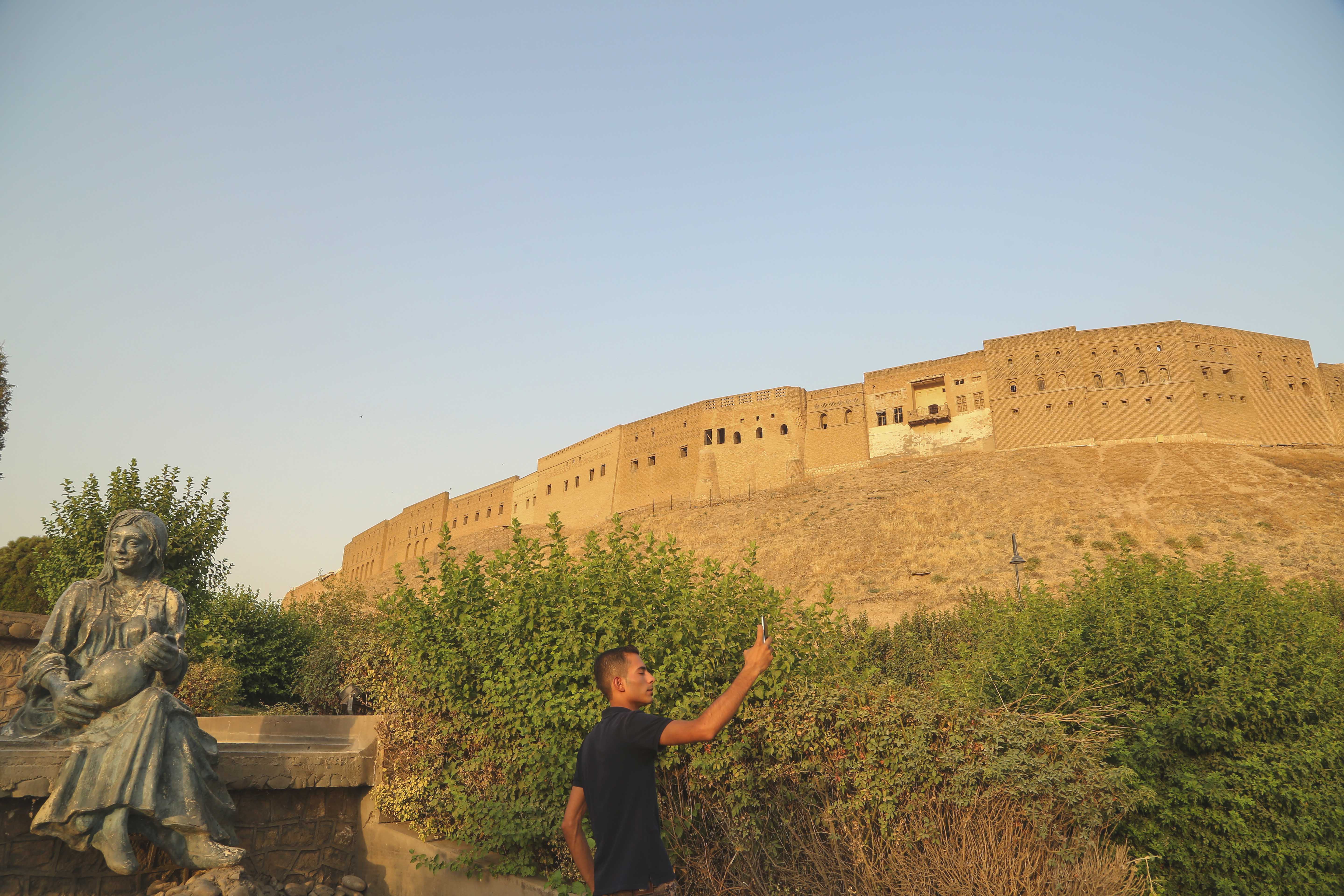 A man takes a selfie at a park near the Erbil Citadel. (Photo: Shvan Harki)