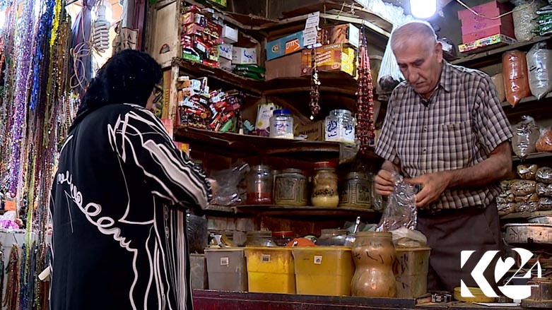 'Ismael the Attar,' or the spice dealer, serves a customer, July 22, 2018. (Photo: Kurdistan 24)
