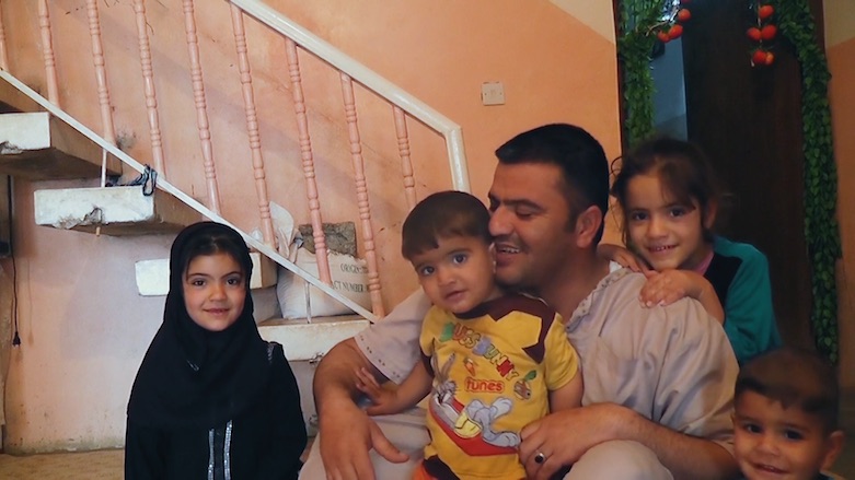 Nori Sharif poses for a photo with his children before they fled their home in Jalawla. (Photo: Ten Thousand Images)