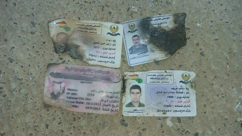 ID cards found among the remains discovered in Hawija. (Photo: Social media)