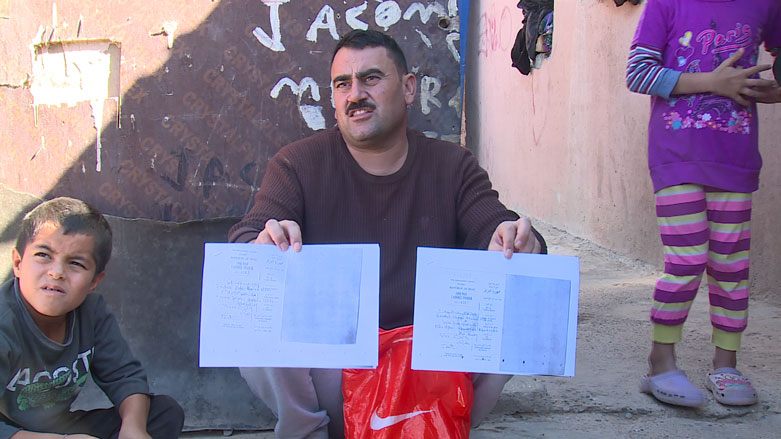 Khero Ido’s brother shows the documents they received from the Embassy of Iraq in Greece, Oct. 30, 2018. (Photo: Kurdistan 24)