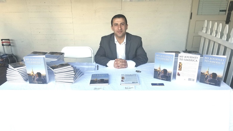 Newzad Brifki during a book-signing session for his memoir, “My Journey to America: A Kurdish-American Story,” about his journey from the Kurdistan Region to the United States. (Photo: Twitter/Newzad Brifki) 