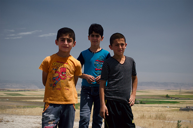 Children atop the archaeological mound in Amiyan village. (Photo: Levi Clancy) 