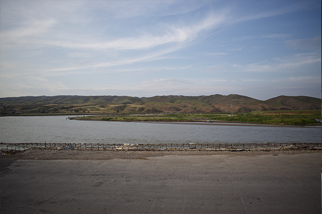 View from the unfinished bridge on the Chemmah way. An unusual but bustling makeshift bazaar has popped up on the bridge itself. (Photo: Levi Clancy) 