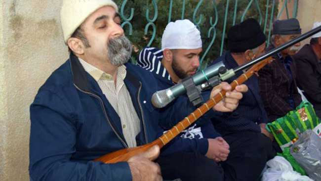 At religious ceremonies, Kakais often play a sacred lute known as the tanbur while reading sacred texts. (Photo: BBC/Behnaz Hosseini)