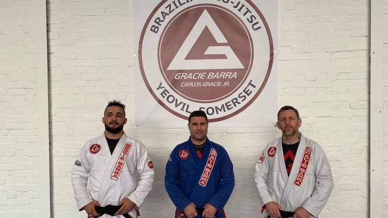 Mario Saeed (left) poses with his black beltat a Brazilian jiu-jitsu gym. (Photo: Facebook/Mario Saeed)