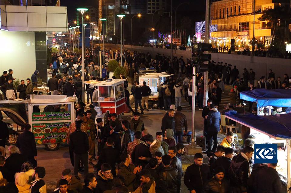 Sulaimani's Salim Street on New Year's eve flooded with locals some of whom paused at food stands for a snack.