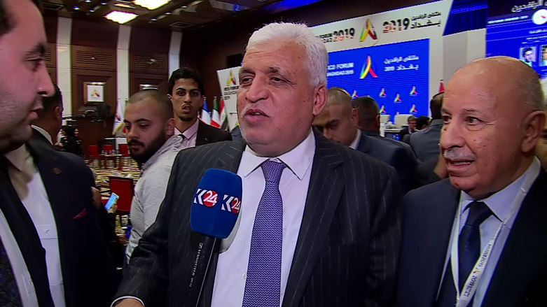 Falih Fayyadh, the National Security Adviser of Iraq, speaks to Kurdistan 24 during a forum in Baghdad standing next to the Kurdistan Region Interior Minister Karim Sinjari. (Photo: Kurdistan 24)