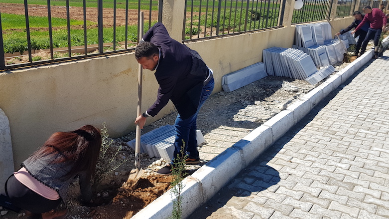 Members of The Green Party of Kurdistan plant olive trees in the town of Hazime in Raqqa's countryside with the support of the local administration, March 18, 2019. (Photo: Kurdistan 24/Wladimir van Wilgenburg)