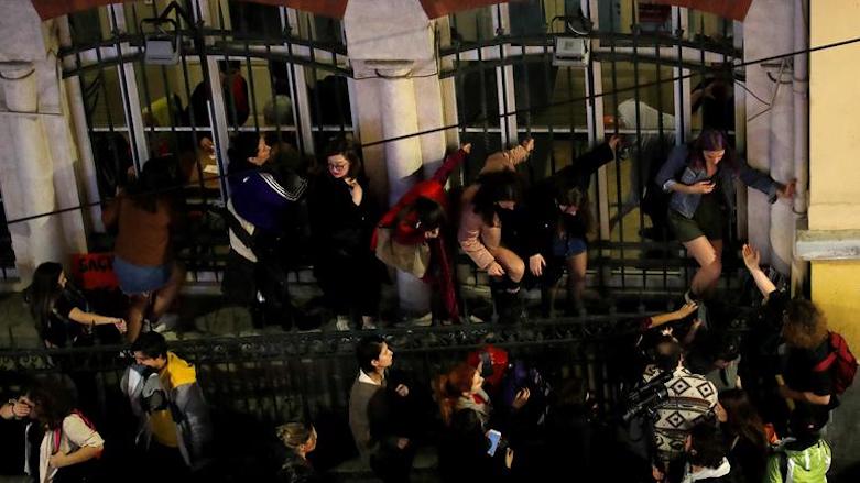 People take cover as police try to disperse a march marking International Women's Day, March 8, 2019, Istanbul, Turkey. (Photo: Reuters)