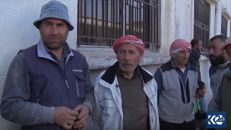 Reid Ibrahim (second from left) among a group of laborers as they wait for employment. (Photo: Kurdistan 24)