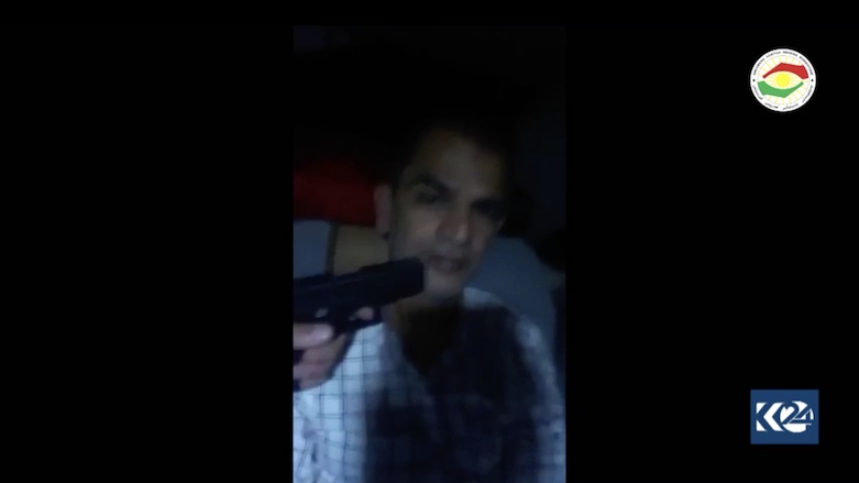 A calm Nasir Ahmed Ghafor is seen in a video with a gun pointed to his head. (Photo: Screengrab/Erbil Asayish)