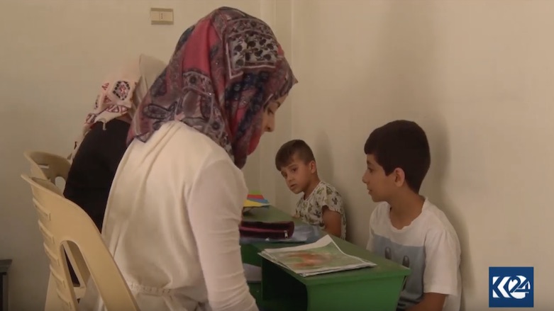 Instructors and caregivers at the center teach the children how to read and write. (Photo: Kurdistan 24)