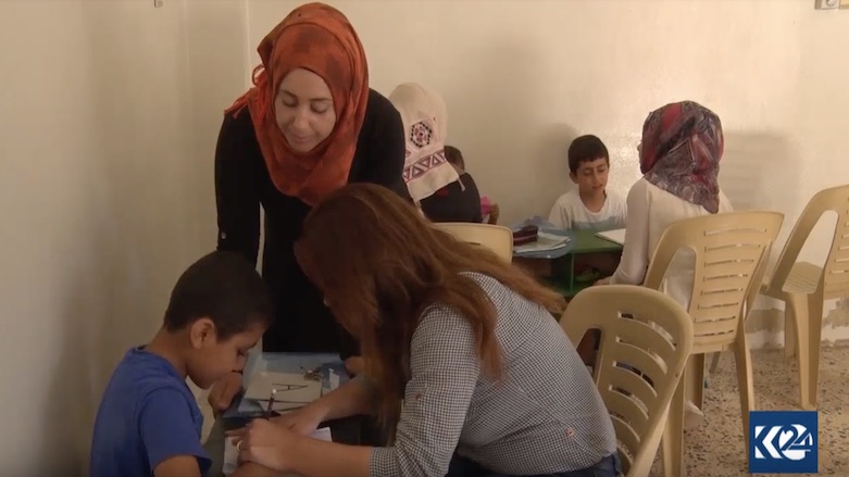 Instructors and caregivers at the center teach the children how to read and write. (Photo: Kurdistan 24)