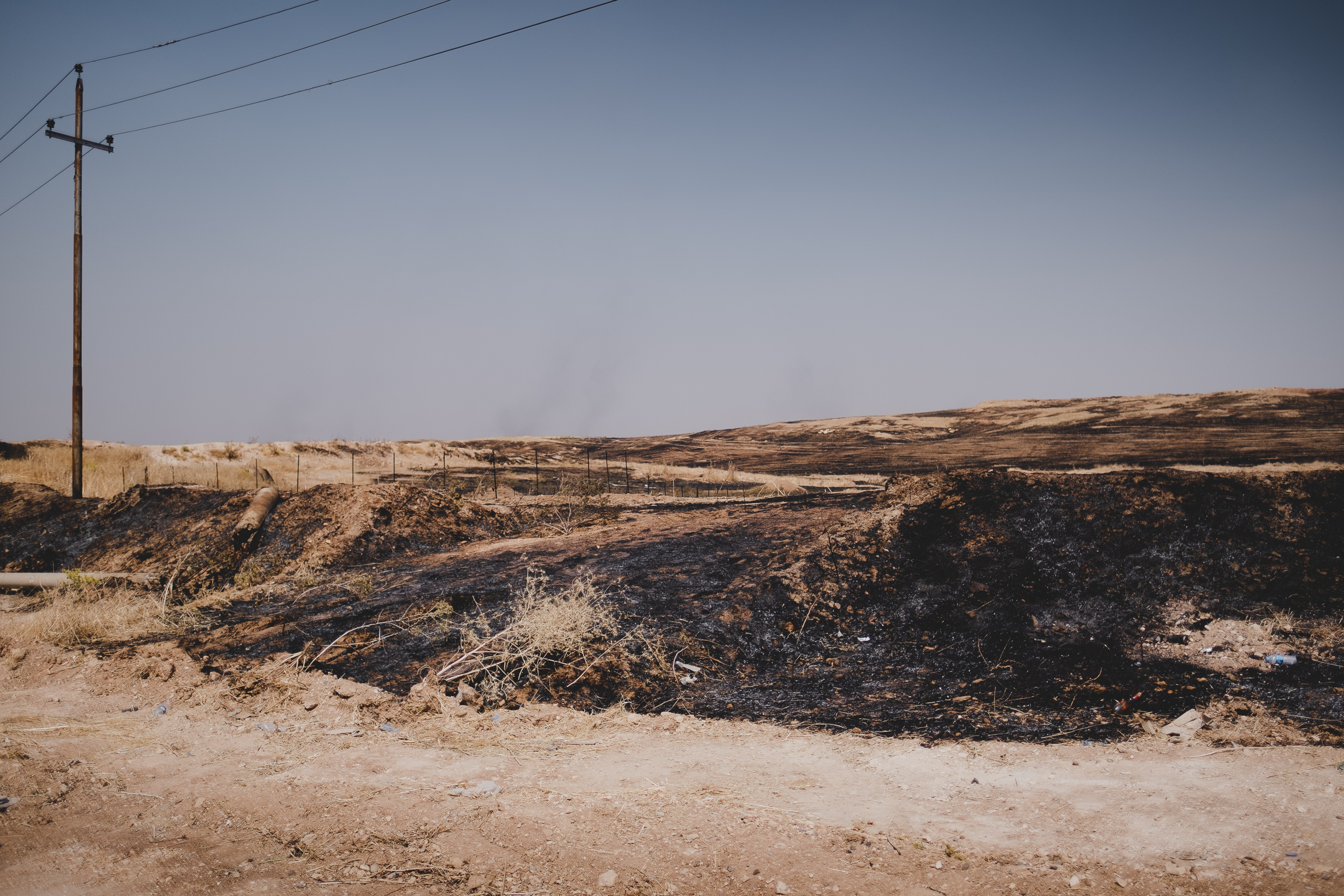 Fire destroyed the mass graves at the Hardan intersection where an estimated 250 Ezidis were executed on Aug. 3 and 4 in 2014. (Photo: Kurdistan 24/Levi Clancy)