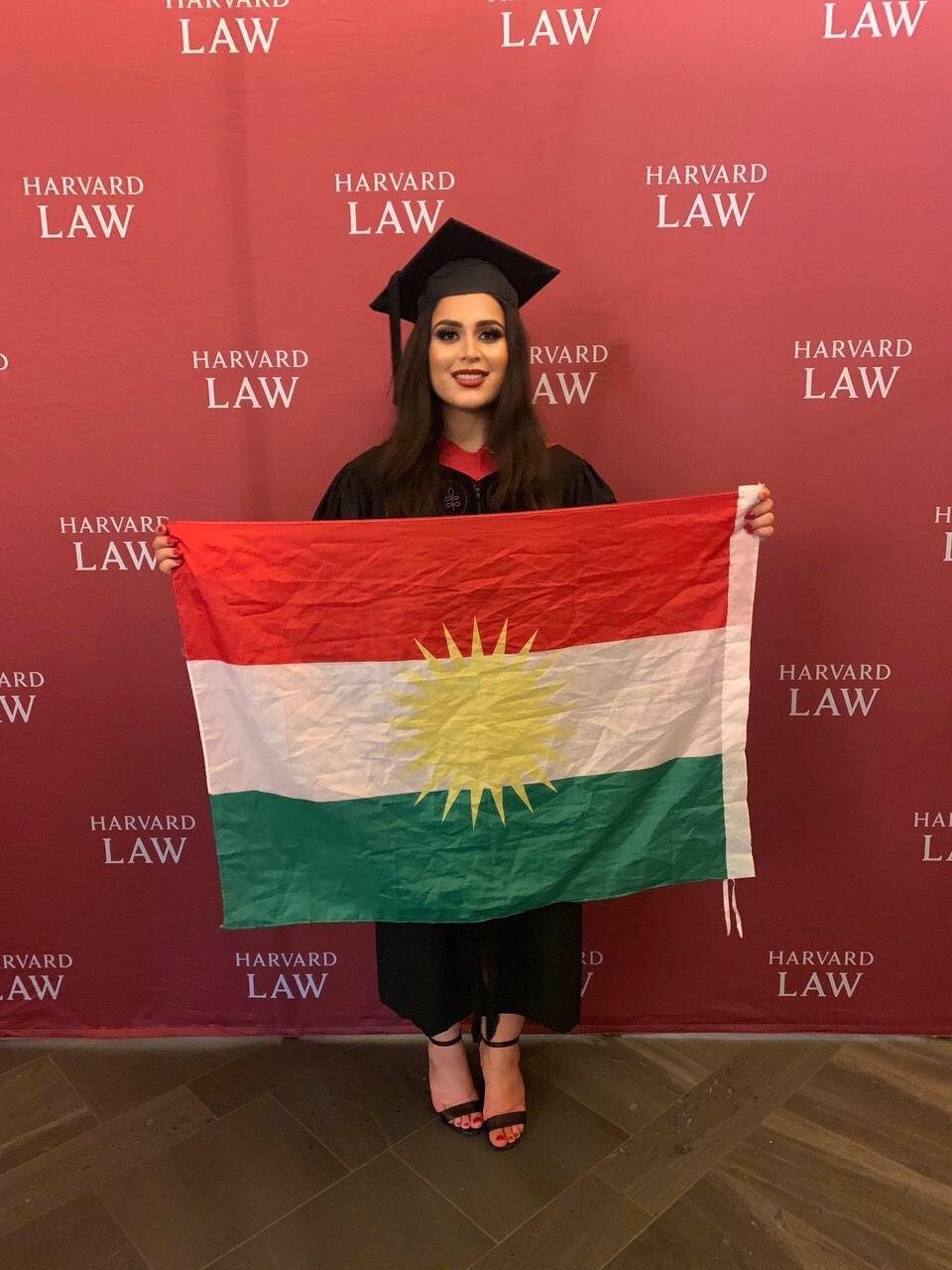Rez Gardi poses with the Kurdistan flag after graduating from Harvard Law School, June 2019. (Photo: Facebook/Rez Gardi)
