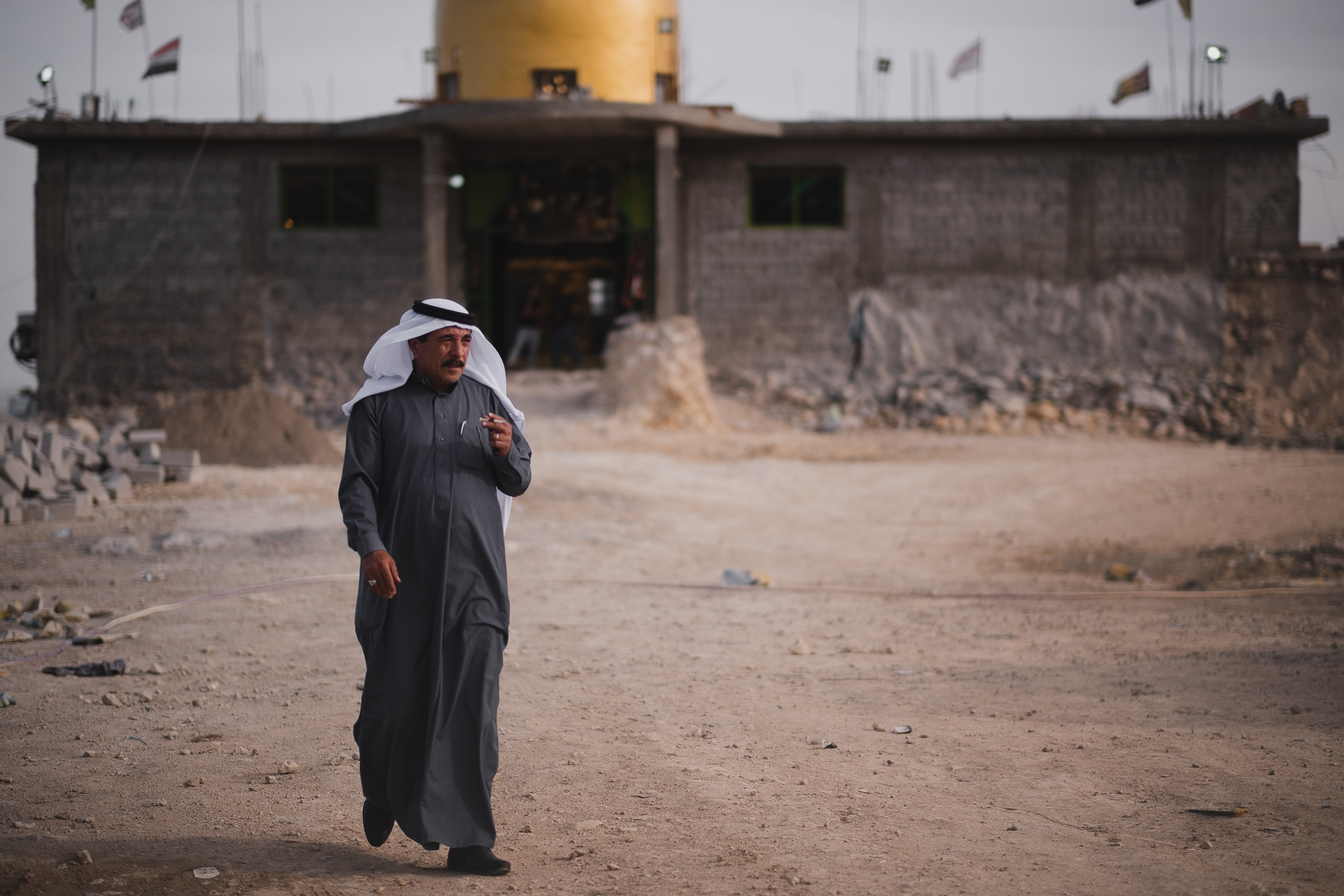 A pilgrim at the shrine of Saida Zeyneb during reconstruction. (Photo: Kurdistan 24/Levi Clancy)