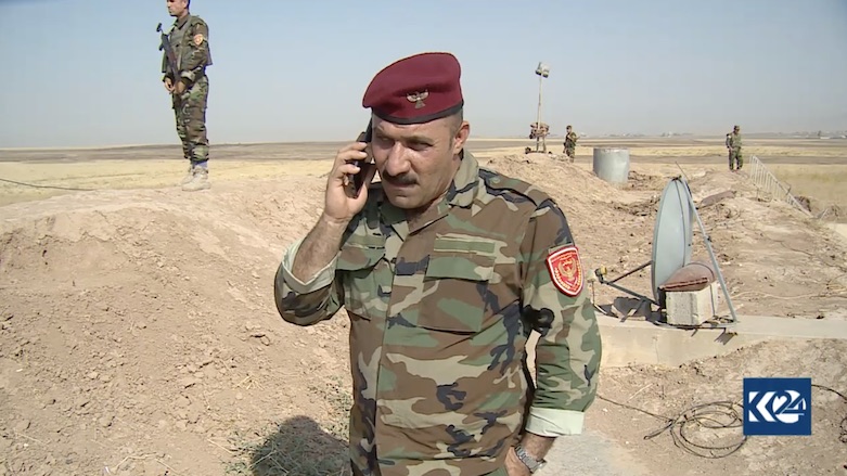 Khalil Abdulla, one of the Peshmerga at the Khazir front line, phones his family to wish them a happy Eid. (Photo: Kurdistan 24)