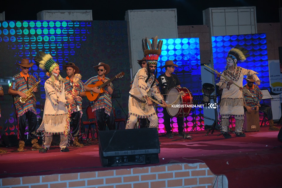 A group of dancers wearing traditional attire performing on stage in the Kurdistan Region city of Rania during a cultural exchange event, Sept. 19, 2019. (Photo: Kurdistan 24/Ismael Shamzini)