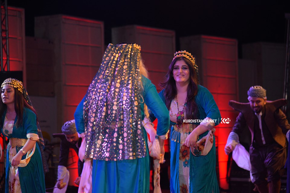 A group of dancers wearing traditional attire performing on stage in the Kurdistan Region city of Rania during a cultural exchange event, Sept. 19, 2019. (Photo: Kurdistan 24/Ismael Shamzini)