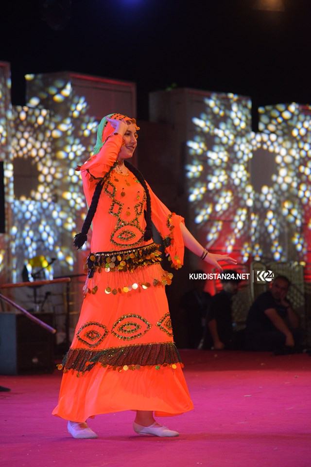 A dancer wearing traditional attire performing on stage in the Kurdistan Region city of Rania during a cultural exchange event, Sept. 19, 2019. (Photo: Kurdistan 24/Ismael Shamzini)