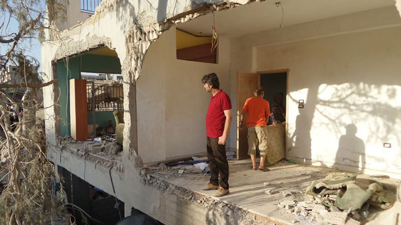 Omer stands in the the remnants of his home, completely demolished in a 2016 double bombing that was claimed by the Islamic State. (Photo: Zana Omer/Social Media)