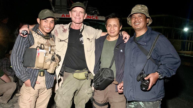 In this undated photo, Zau Seng (right) is seen with other volunteers and FBR head Dave Eubank (center left). (Photo: FBR)