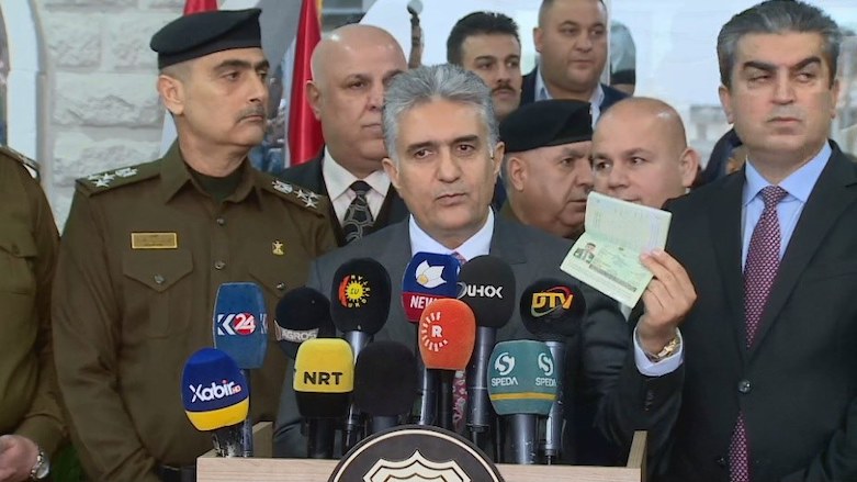 Kurdistan Region Interior Minister Rebar Ahmed holds up the first printed and stamped passport at the new passport office in Zakho, Dec. 10, 2019. (Photo: Kurdistan 24)