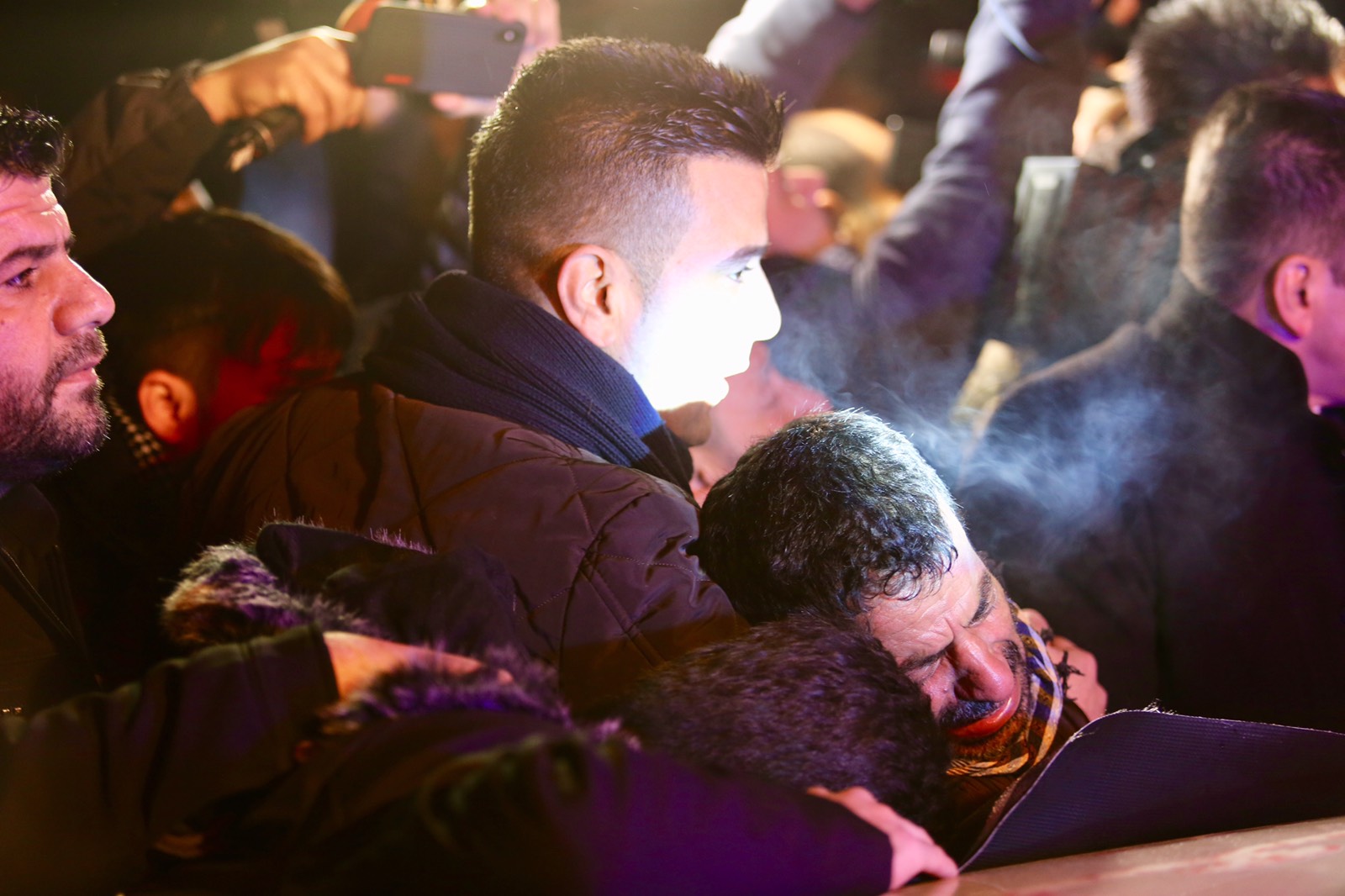 Grieving families in the Kurdistan Region's city of Sulaimani receive the bodies of five persons who recently died after a boat carrying them sank in the territorial waters between Greece and Italy, Jan. 25, 2020. (Photo: Kurdistan 24)