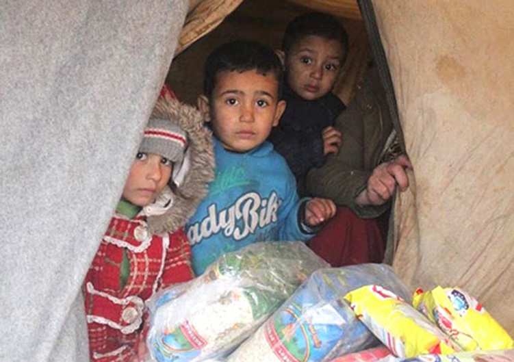 Syrian children living at a camp in the northern city of Manbij receive a shipment of humanitarian aid, Feb. 8, 2020 (Photo: Free Burma Rangers)