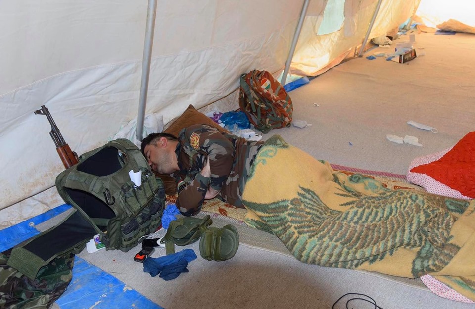 Security forces in Erbil take turns resting while enforcing the regionwide curfew. (Photo: Kurdistan 24)