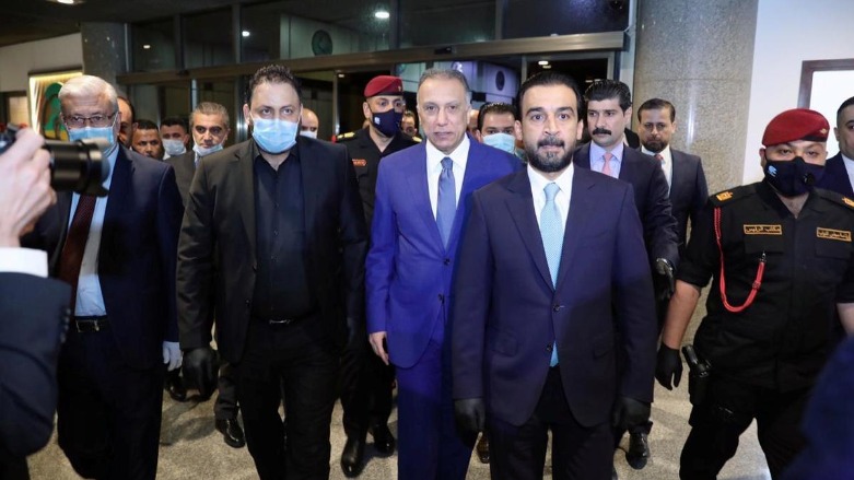 Iraqi Parliament Speaker Mohammed al-Halbousi (front) receives Iraqi Prime Minister-designate Mustafa al-Kadhimi (center) before the vote on his proposed government, Baghdad, May 6, 2020. (Photo: Iraqi Parliament Media Office/Handout via Reuters)