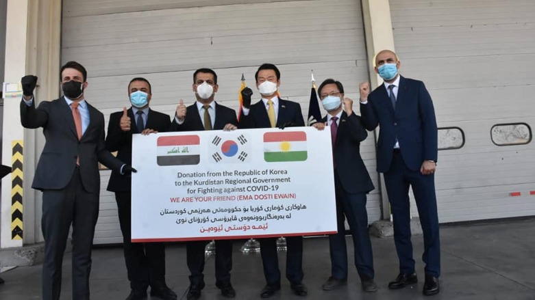 Kurdistan Region health minister Saman Barzinjy receives a coronavirus aid package from the South Korean consul-general to Erbil, Choi Kwang-Jin. (Photo: KRG)